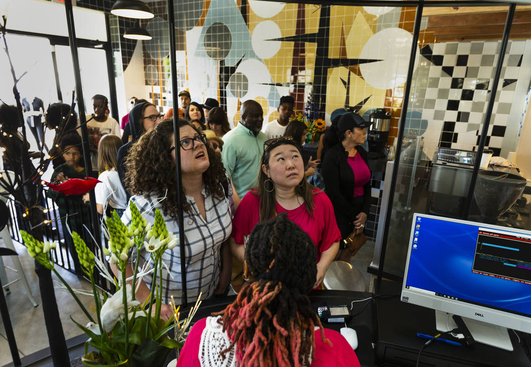 Guests order up a nice cup of coffee for sale during the grand opening of the new iteration of ...