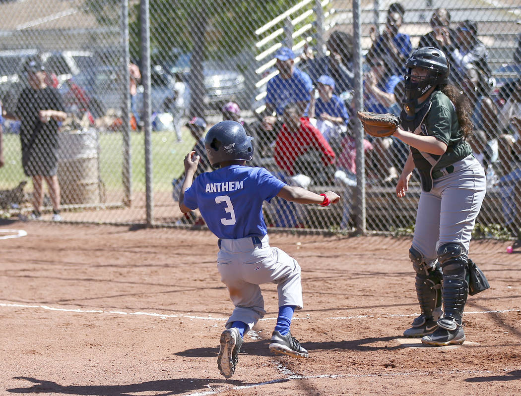 Rangers' Jay Jay Nichols, 12, scores a run against the Bulldogs during the opening day celebrat ...