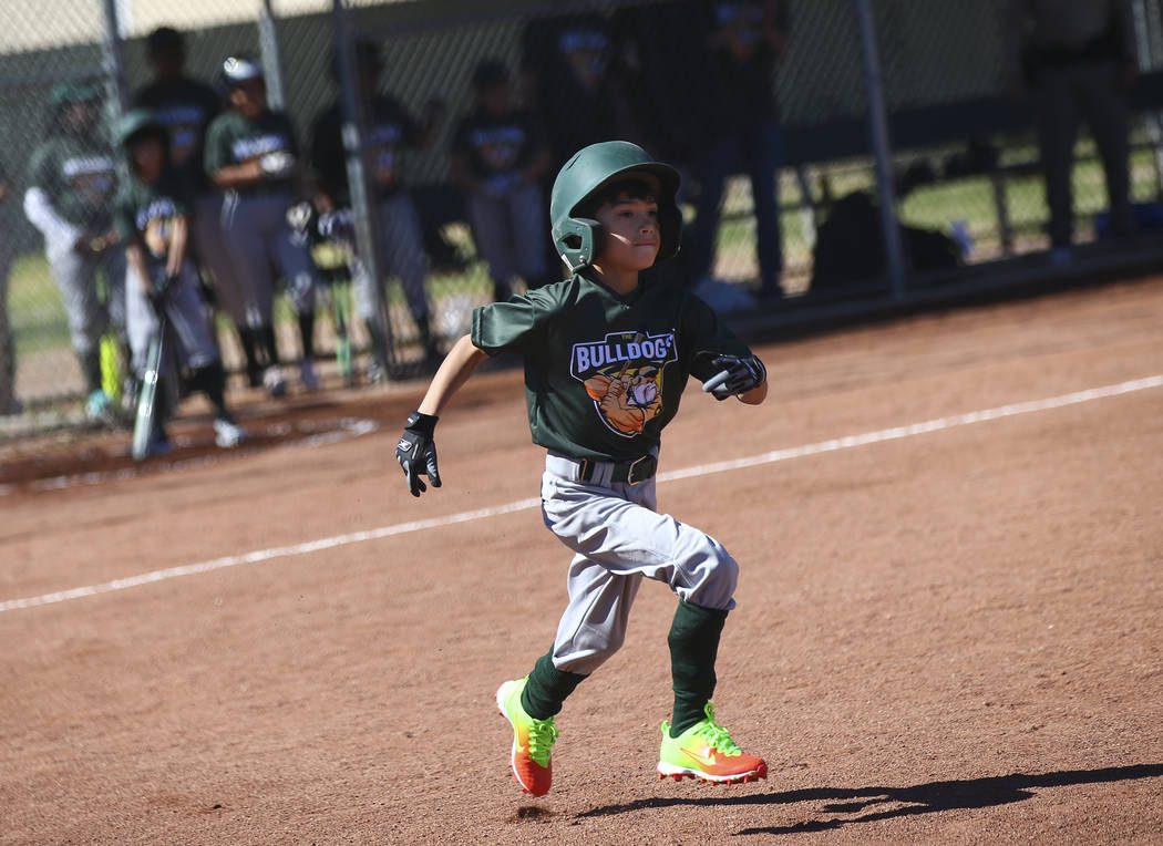 Bulldogs' Nathan Pineda, 9, runs to first base while playing against the Rangers during the ope ...