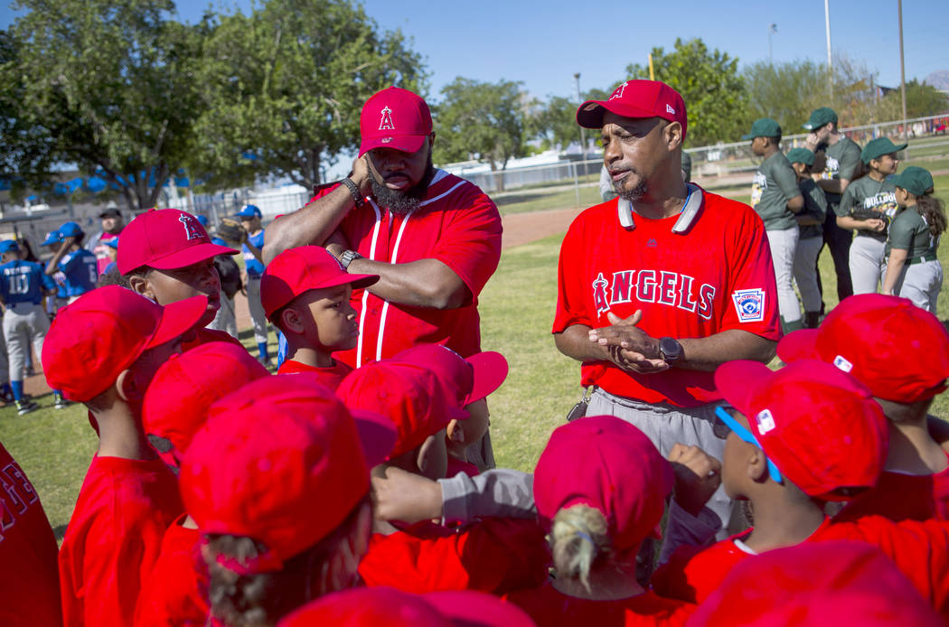 Dale Johnson, coach of the Angels, right, talks with his players during the opening day celebra ...