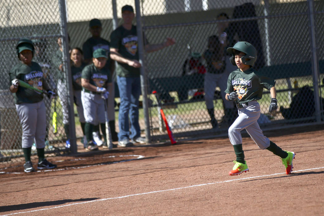 Bulldogs' Nathan Pineda, 9, heads to home plate to score a run against the Rangers during the o ...