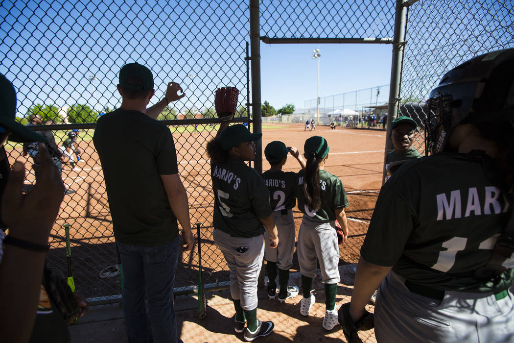 Members of the Bulldogs team watch the action during the opening day celebration for the third ...