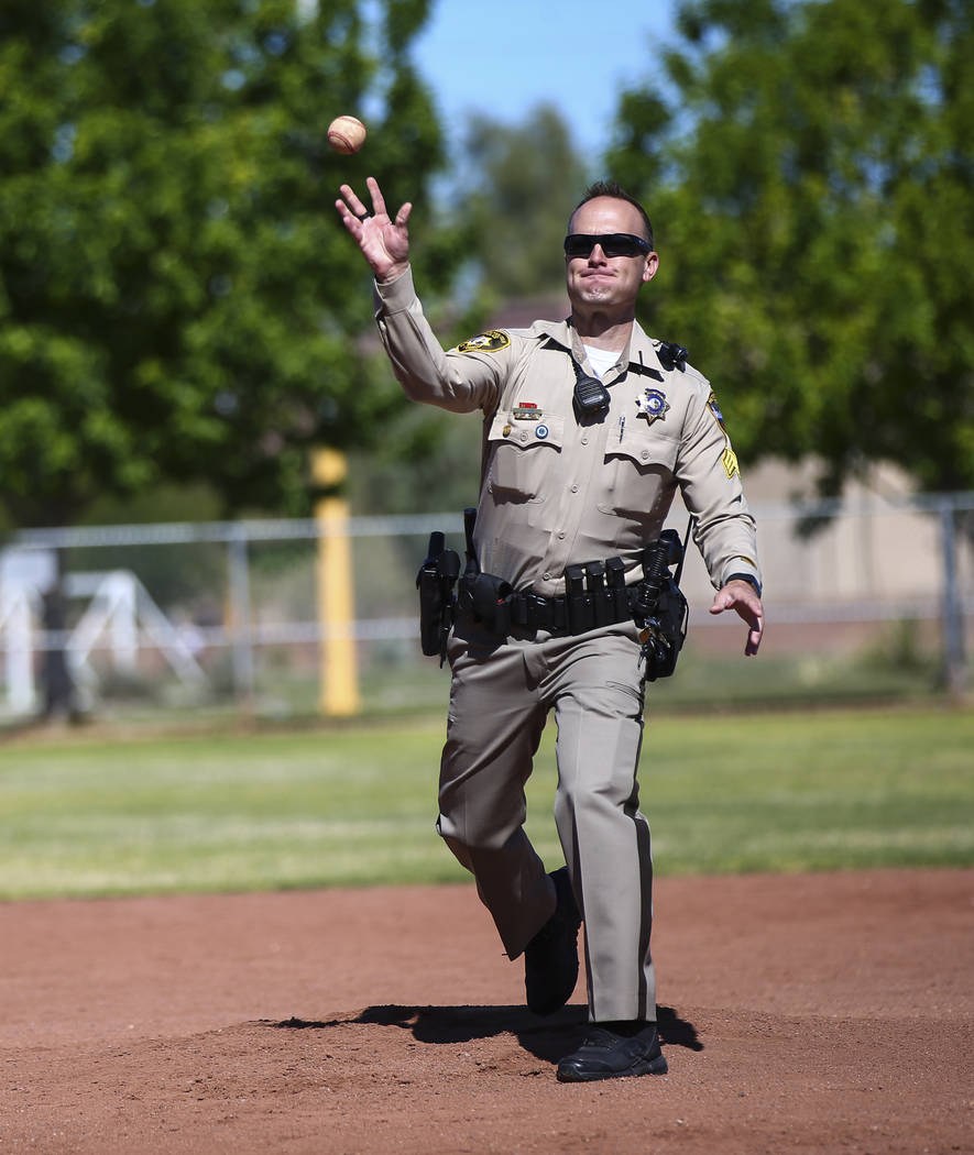 Las Vegas police Sgt. Joshua Stark throws the first pitch during the opening day celebration fo ...