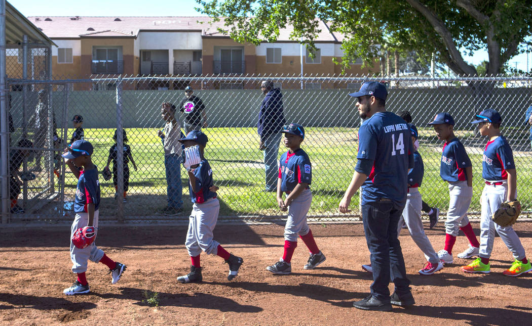 Members of the Red Sox team leave the field before the start of a game on the opening day for t ...