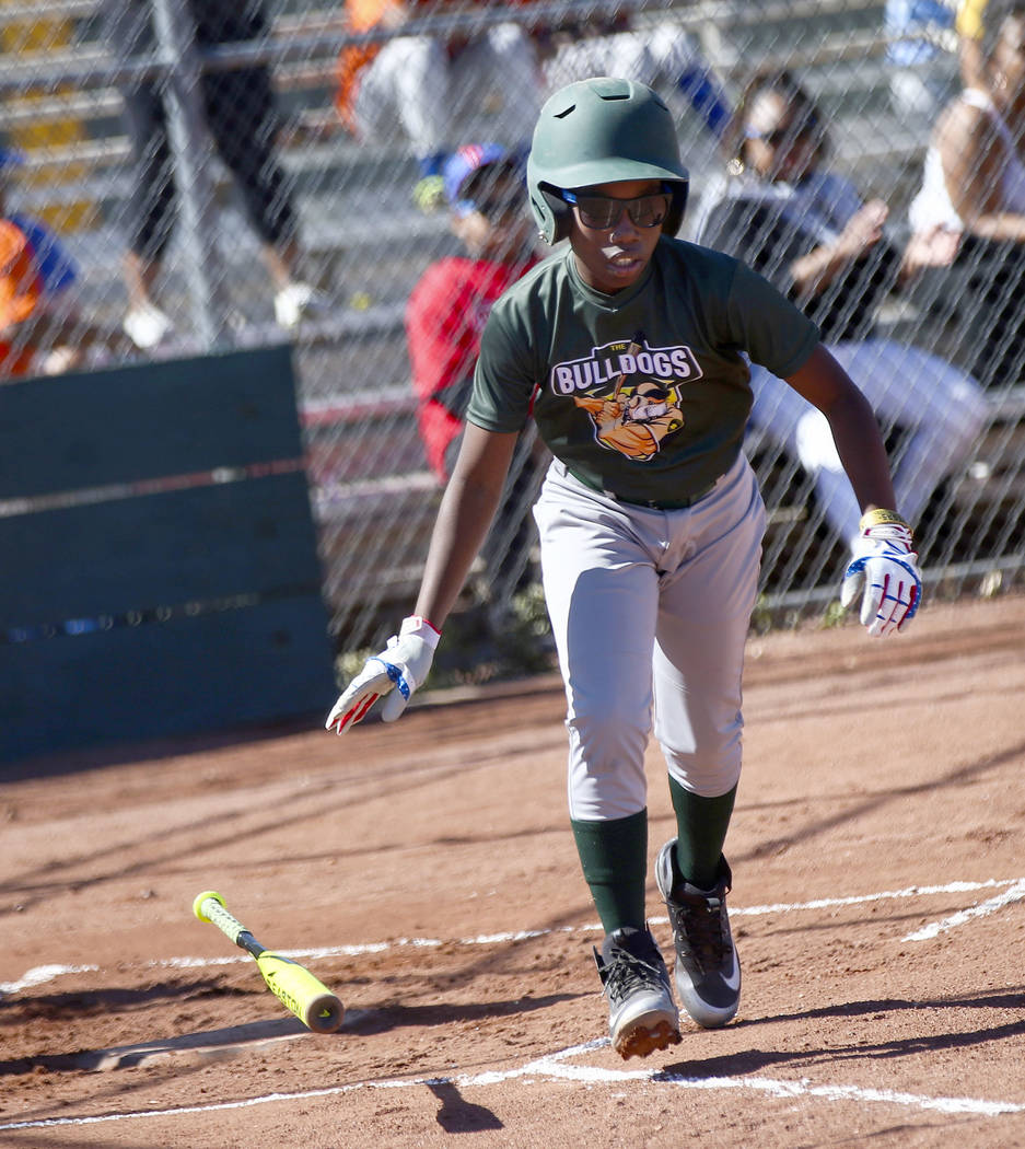 Bulldogs' Marcel Elzy, 12, runs to first base while playing against the Rangers during the open ...