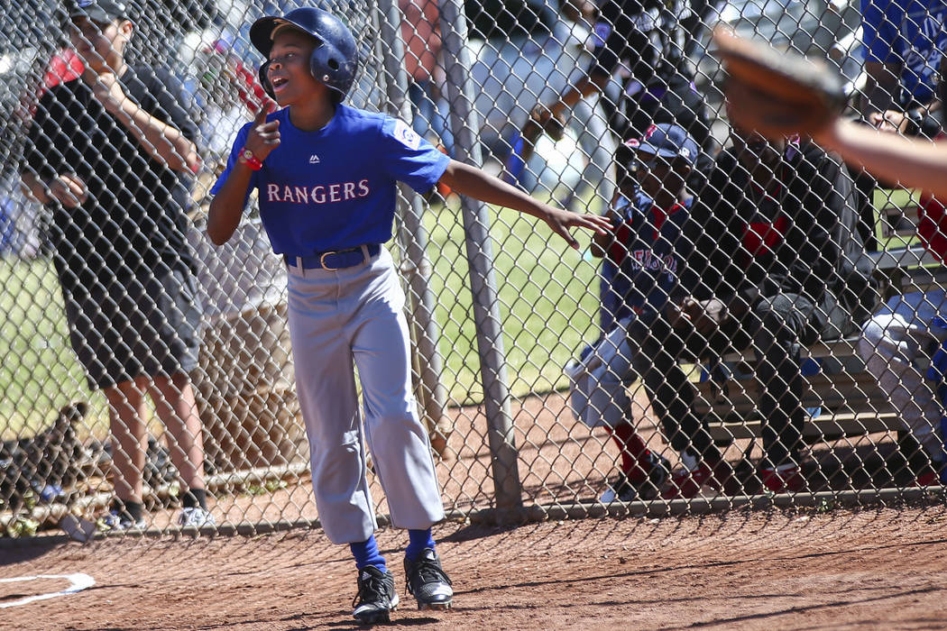 Rangers' Jay Jay Nichols, 12, celebrates after scoring a run against the Bulldogs during the op ...