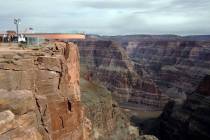 The Skywalk is slowly moved out over the rim of the Grand Canyon before a throng of VIP guests ...