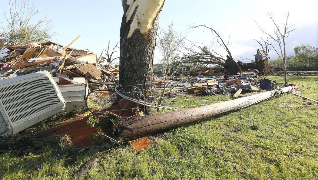 In this image made with a wide angle lens, debris is littered on the ground where a home once s ...
