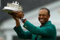 Tiger Woods wears his green jacket holding the winning trophy after the final round for the Mas ...