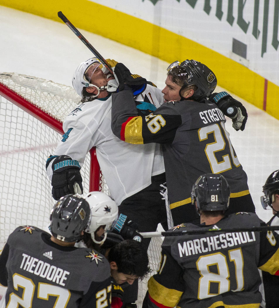 San Jose Sharks defenseman Brenden Dillon (4) is driven back onto the net by Vegas Golden Knigh ...