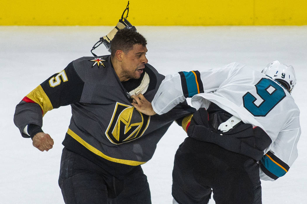 Golden Knights right wing Ryan Reaves (75) fights with San Jose Sharks left wing Evander Kane ( ...