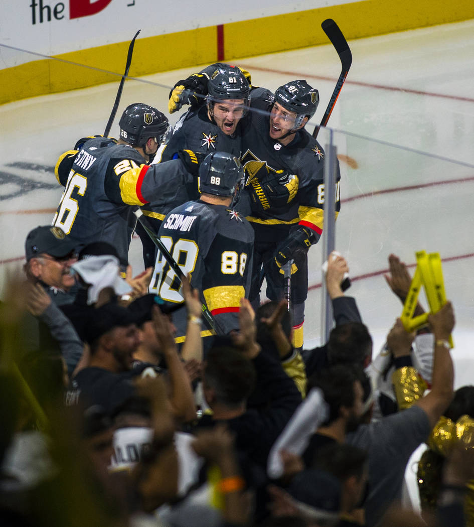Golden Knights players celebrate the "hat trick" by their right wing Mark Stone (61) ...