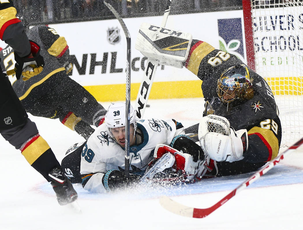 San Jose Sharks center Logan Couture (39) crashes into Golden Knights goaltender Marc-Andre Fle ...