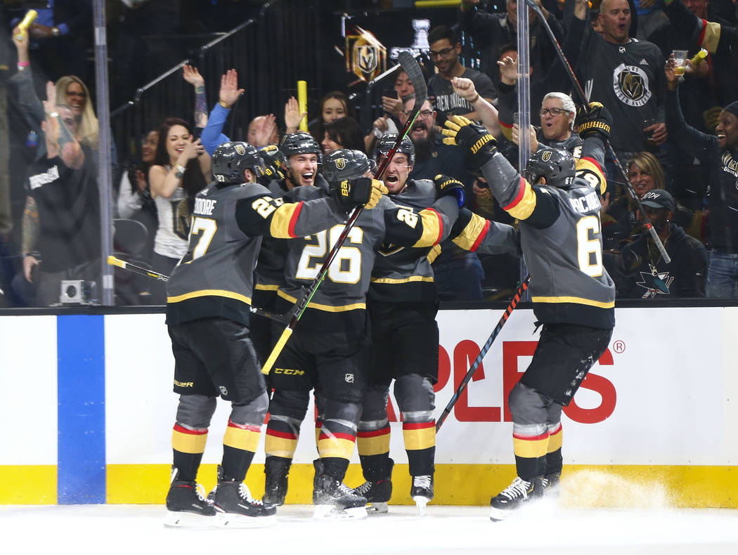 Golden Knights players celebrate a hat trick by Golden Knights right wing Mark Stone, second fr ...