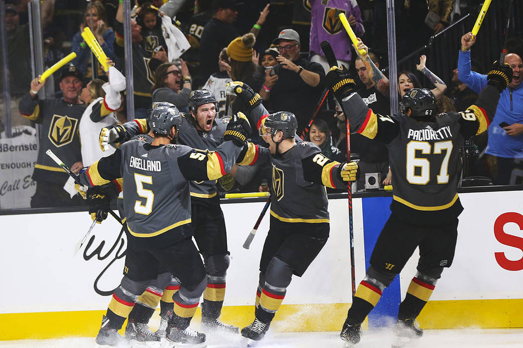 Golden Knights right wing Mark Stone, second from left, celebrates his goal with teammates Dery ...
