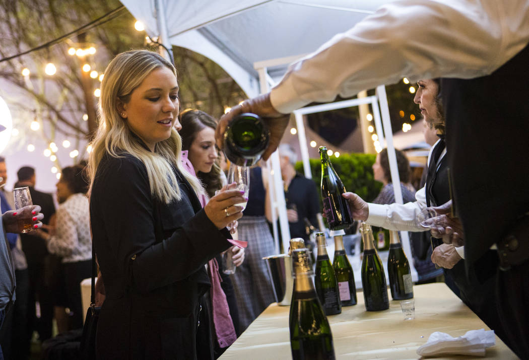 Logan Beierschmitt, of Las Vegas, samples champagne during Bubble-Licious, the UNLVino kickoff ...