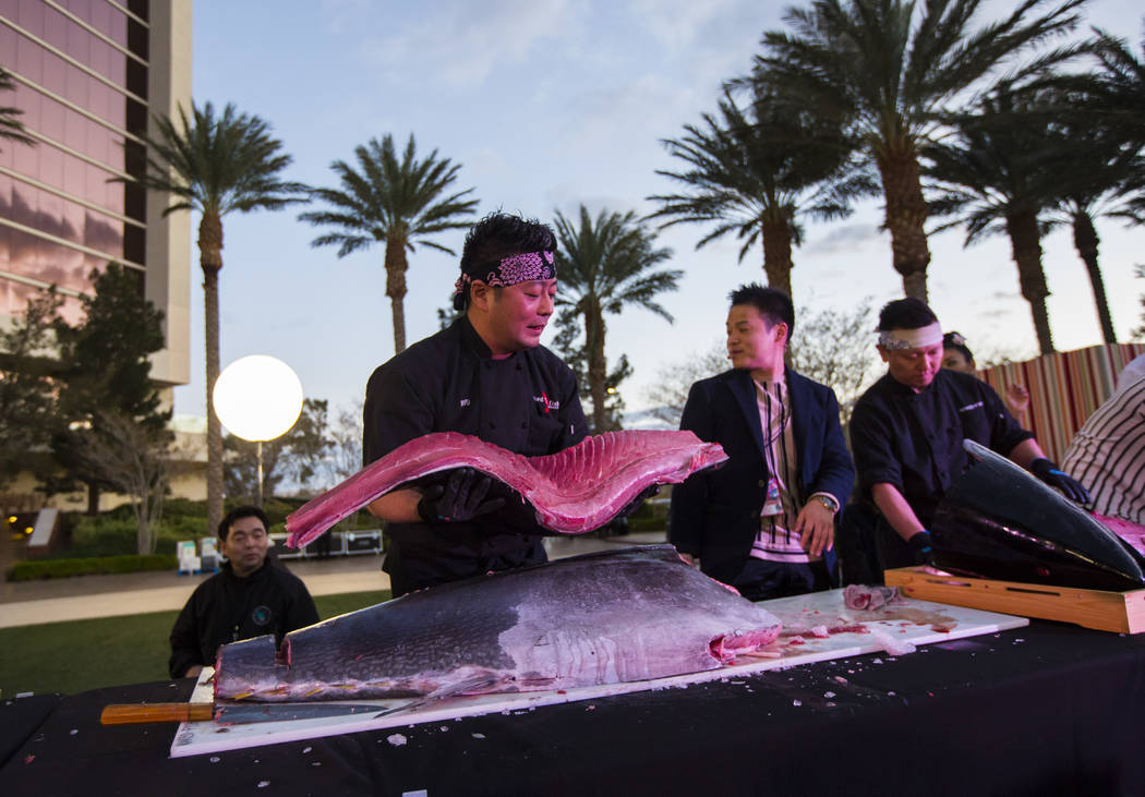 Naked Fish Executive Chef Ryusuke Ikai holds up a piece of bluefin tuna weighing nearly 300 pou ...
