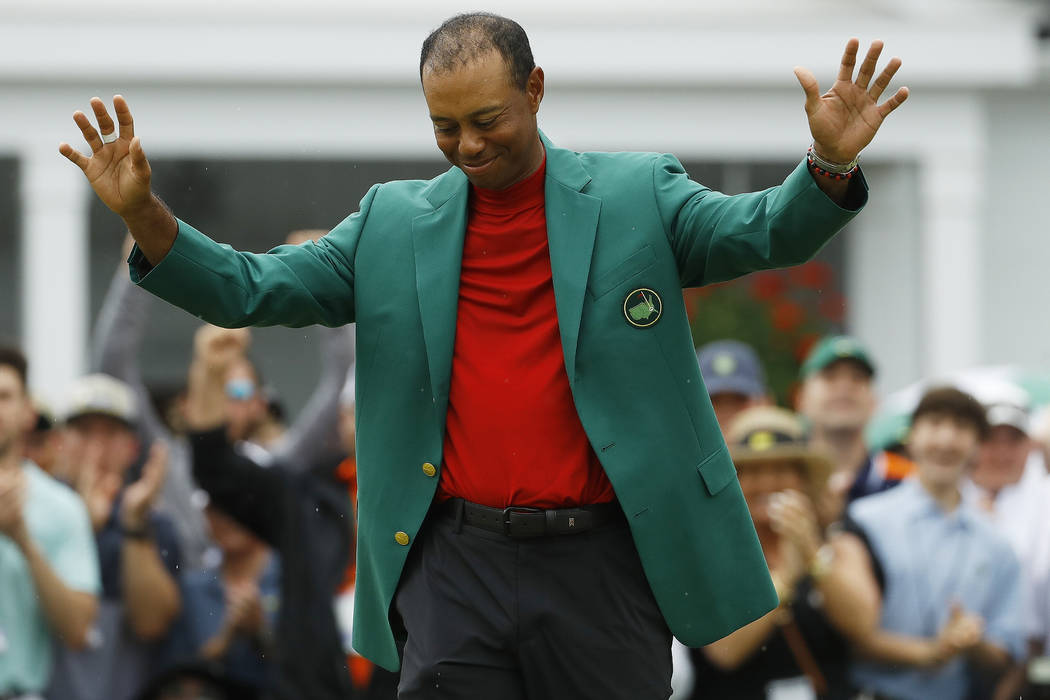 Tiger Woods smiles as he wears his green jacket after winning the Masters golf tournament Sunda ...