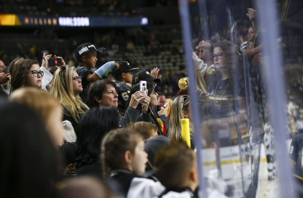 Golden Knights fans watch as players warm up before Game 3 of an NHL Western Conference quarter ...