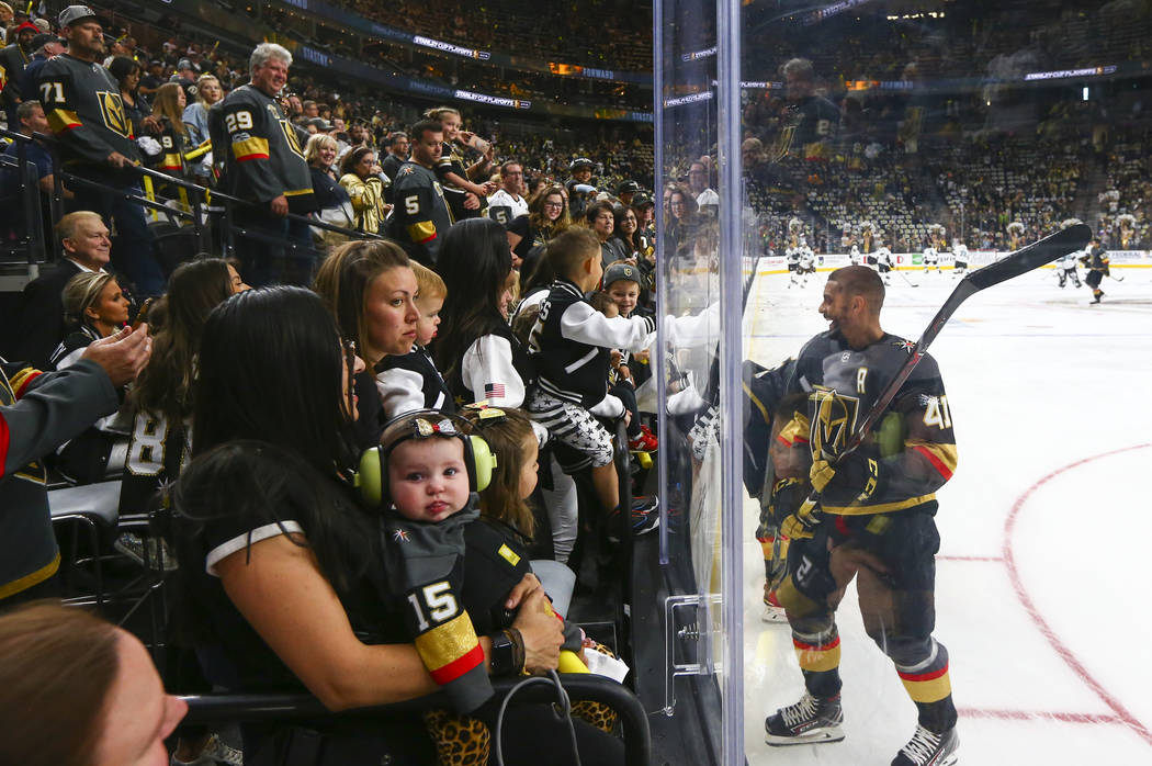 Golden Knights center Pierre-Edouard Bellemare (41) visits with family and friends while warmin ...