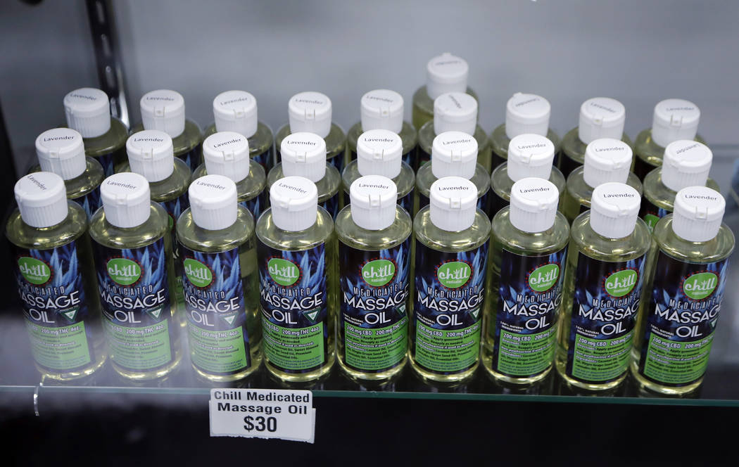 FILE - In this Nov. 7, 2018, file photo, bottles of massage oil with cannabidiol (CBD) and tetr ...
