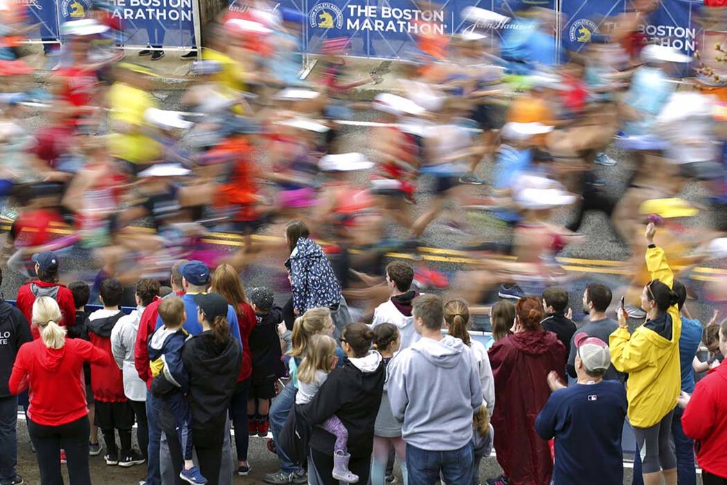 Fans cheer on the third wave of runners at the start of the 123rd Boston Marathon on Monday, Ap ...
