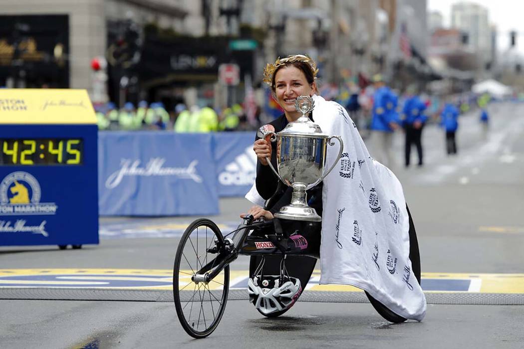 Manuela Schar, of Switzerland, poses with the trophy after winning the women's handcycle divisi ...