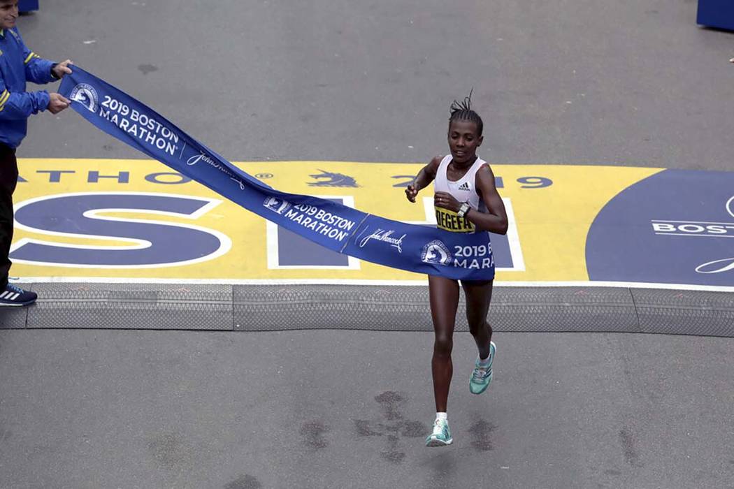 Worknesh Degefa, of Ethiopia, breaks the tape to win the women's division of the 123rd Boston M ...