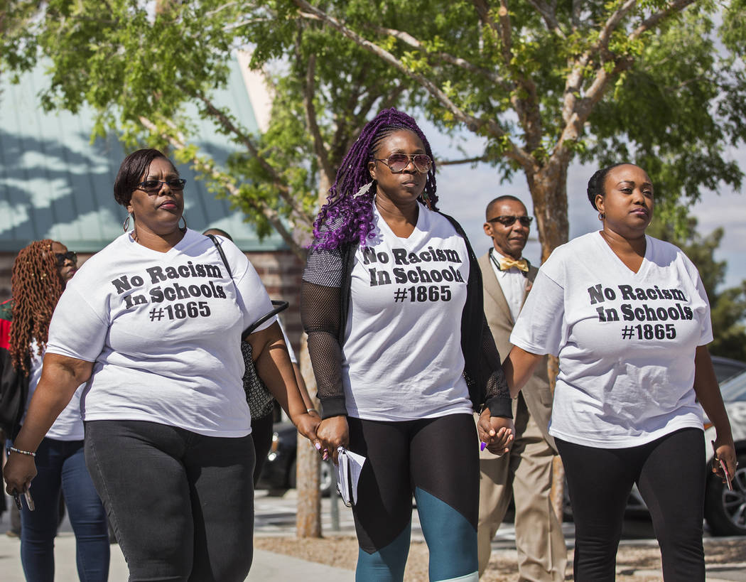 Consuela Nicole, left, Akiko Cooks and Jshauntae Marshall walk hand-in-hand outside the Family ...