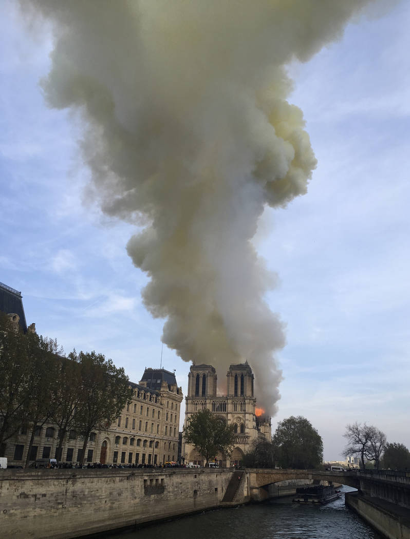 Notre Dame cathedral is burning in Paris, Monday, April 15, 2019. Massive plumes of yellow brow ...