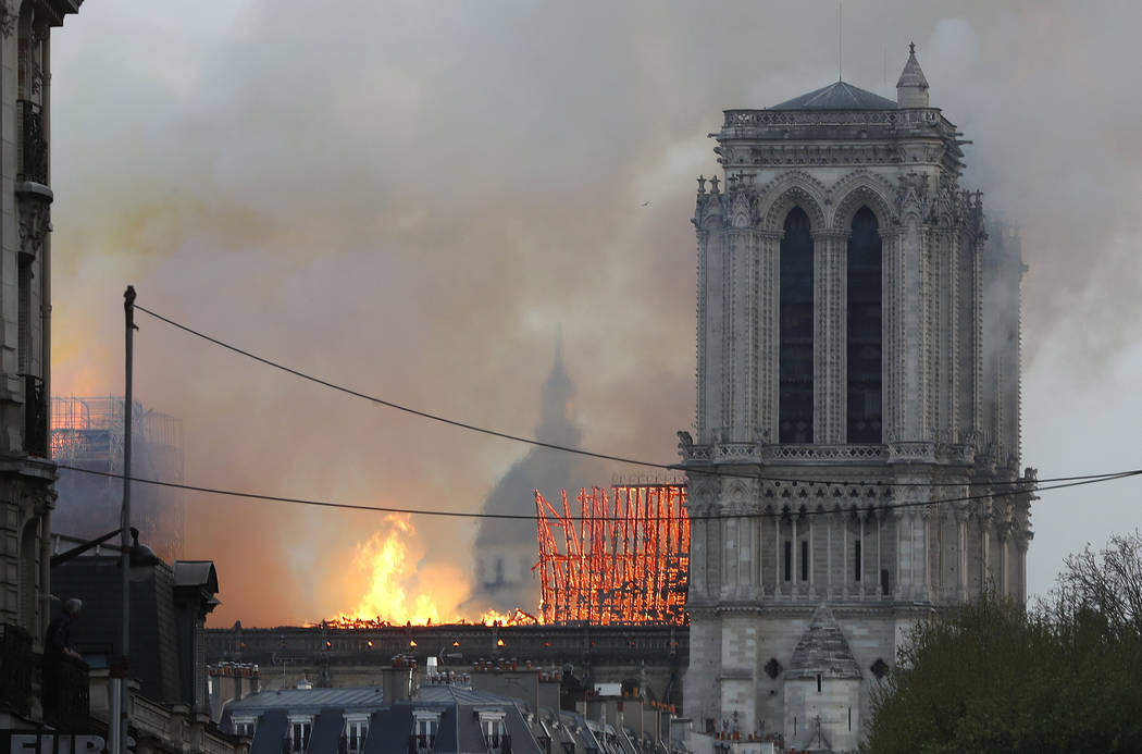 Flames rise from Notre Dame cathedral as it burns in Paris, Monday, April 15, 2019. Massive plu ...