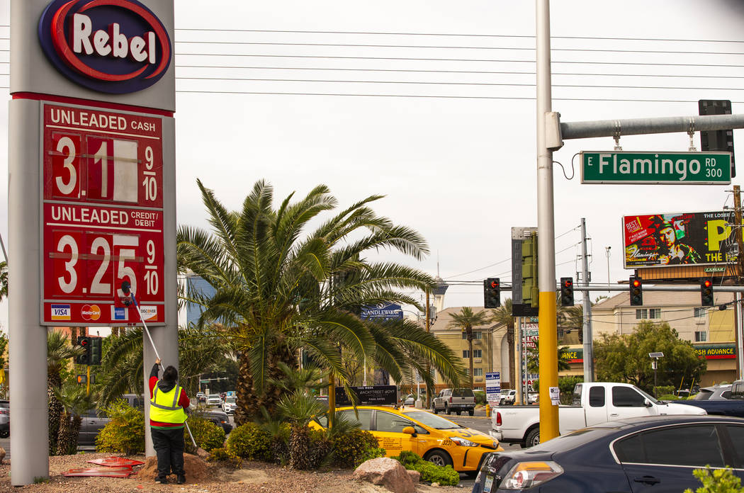 Rebel gas station asst. manager Michael Nunez puts up new gas prices at their station on E. Fla ...