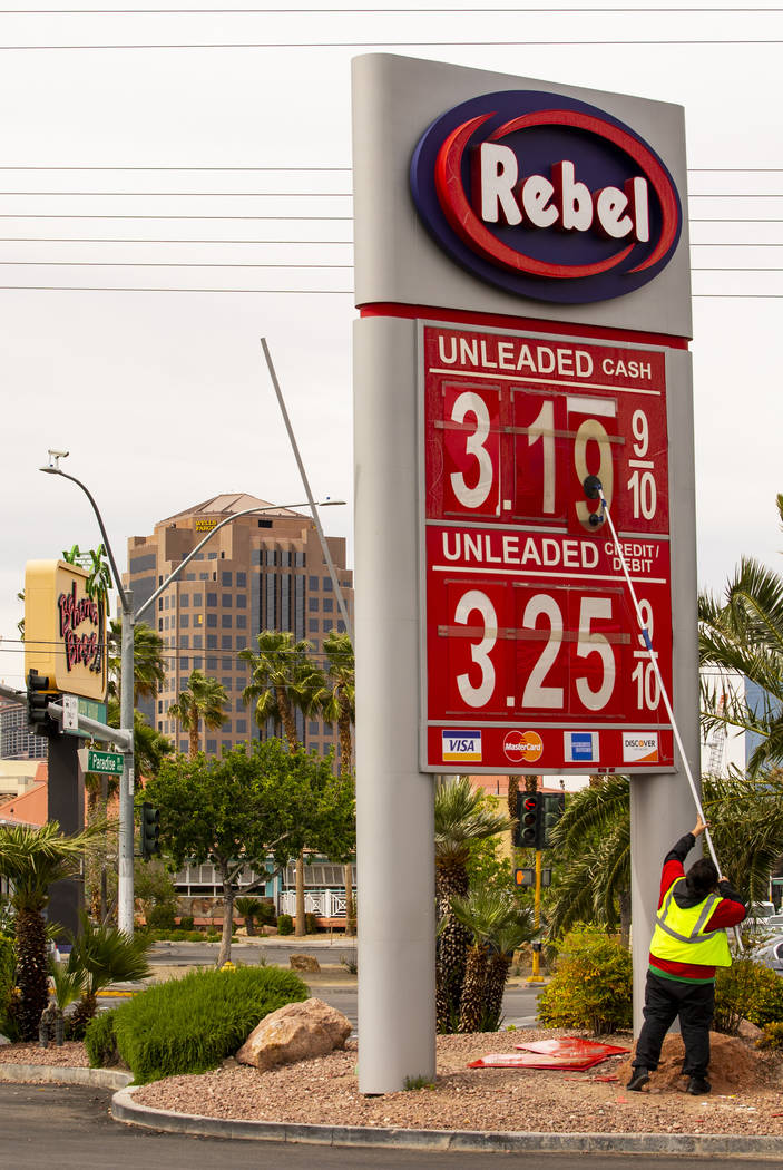 Rebel gas station asst. manager Michael Nunez puts up new gas prices at their station on E. Fla ...