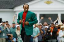 Tiger Woods smiles as he wears his green jacket after winning the Masters golf tournament Sunda ...