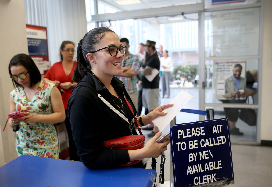 Drea Hopper, 35, of Las Vegas, waits to mail her taxes at the Downtown Las Vegas Post Office Mo ...