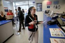 Drea Hopper, 35, of Las Vegas, mails her taxes at the Downtown Las Vegas Post Office Monday, Ap ...