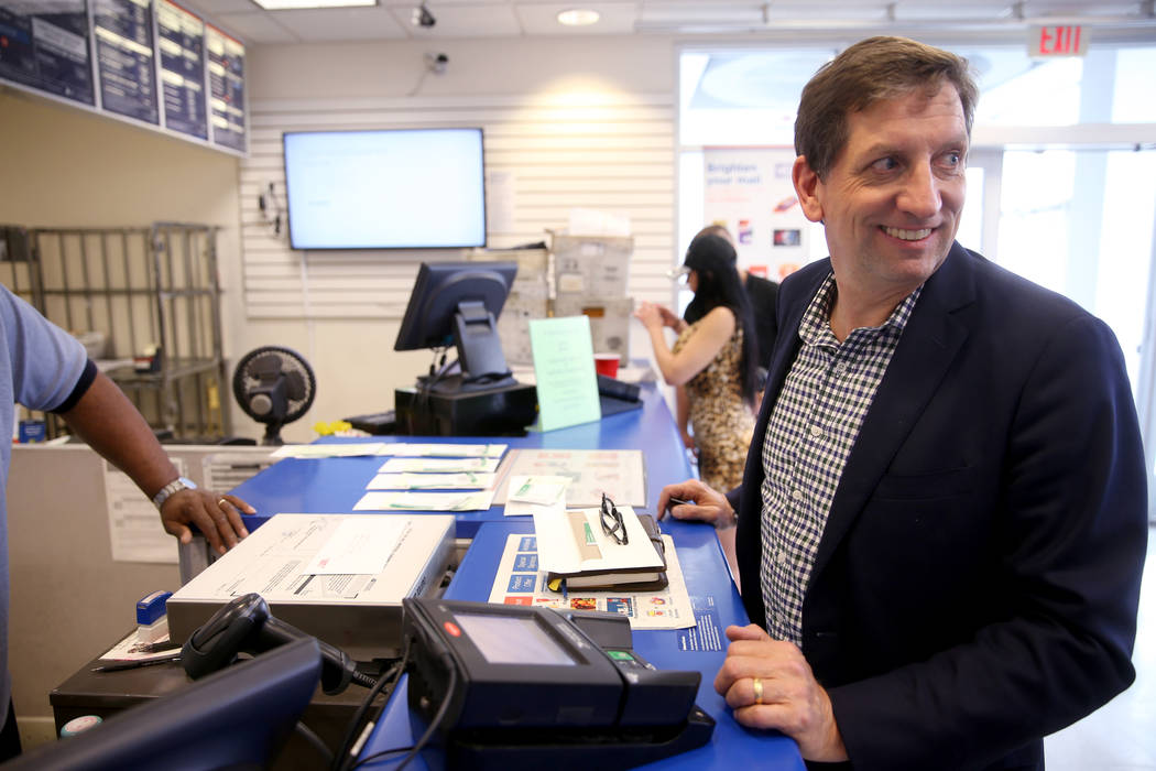 Mike Myers, of Weston, Massachusetts, looks back at the line as he mails multiple tax returns a ...