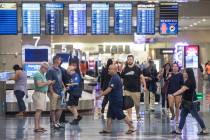 Passengers walk through Terminal 1 baggage claim at McCarran International Airport on Thursday, ...