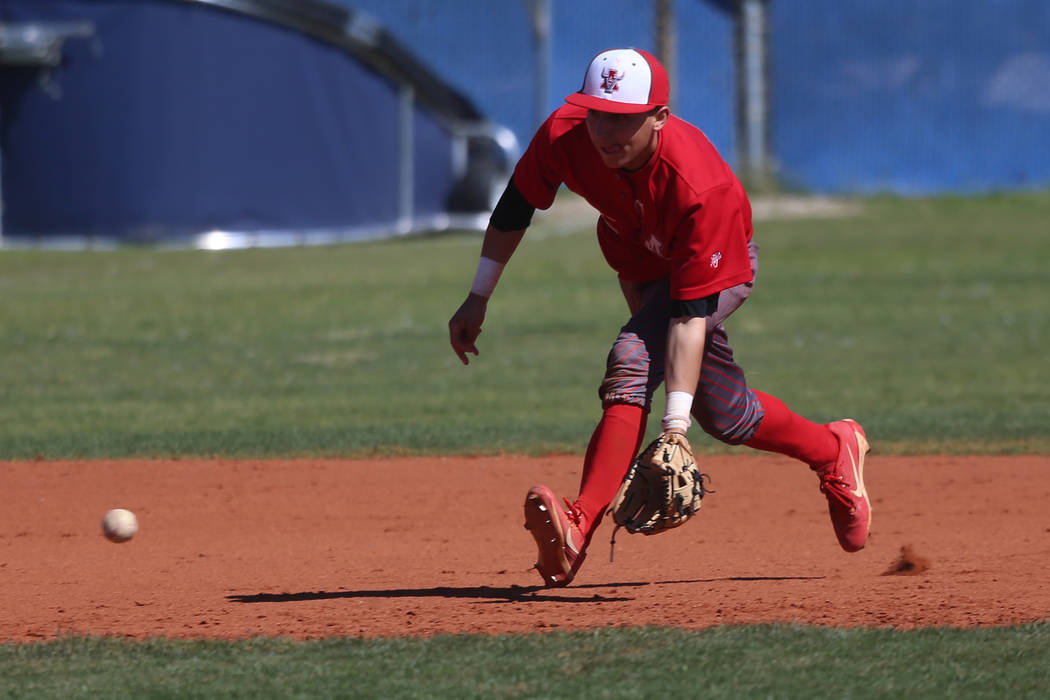Arbor View's Nicholas Cornman (2) picks up a ground ball before throwing to first base for an o ...