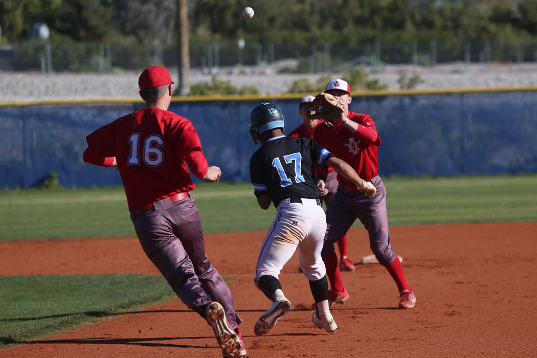 Arbor View's Jacob Scioli (16) throws the ball to Brad Stone (4) to tag out Carson's Nathan Max ...