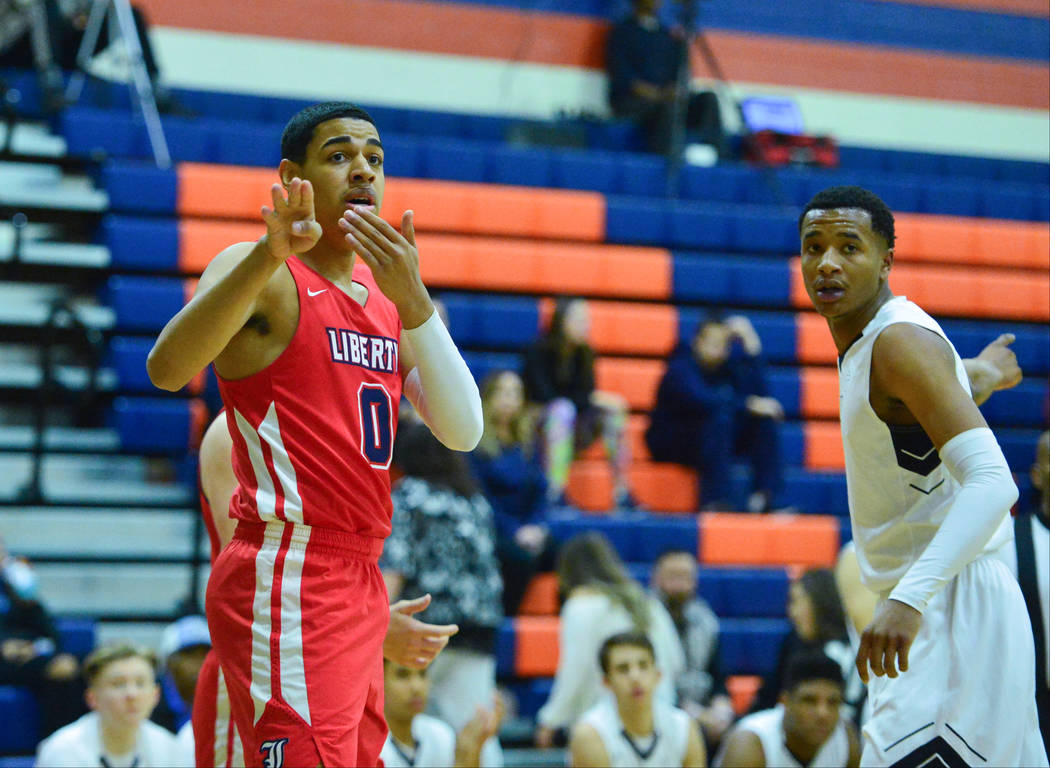 Liberty's Julian Strawther (0) tries to persuade a referee for possession on an out of bounds c ...
