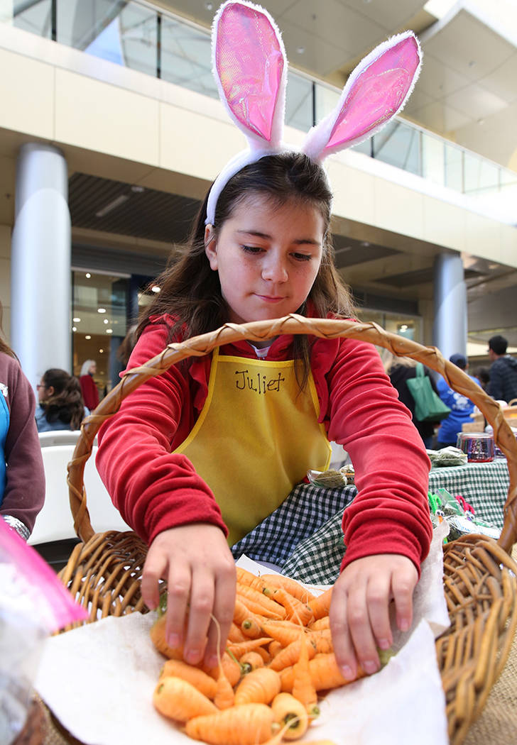 Newton Elementary School student Juliet Robertson, 10, displays baby carrots at Green Our Plane ...