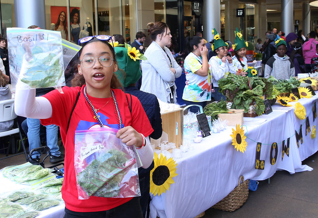 J.E. Manch Elementary School student Miasia Sanders, 11, displays basil and rainbow chard at G ...