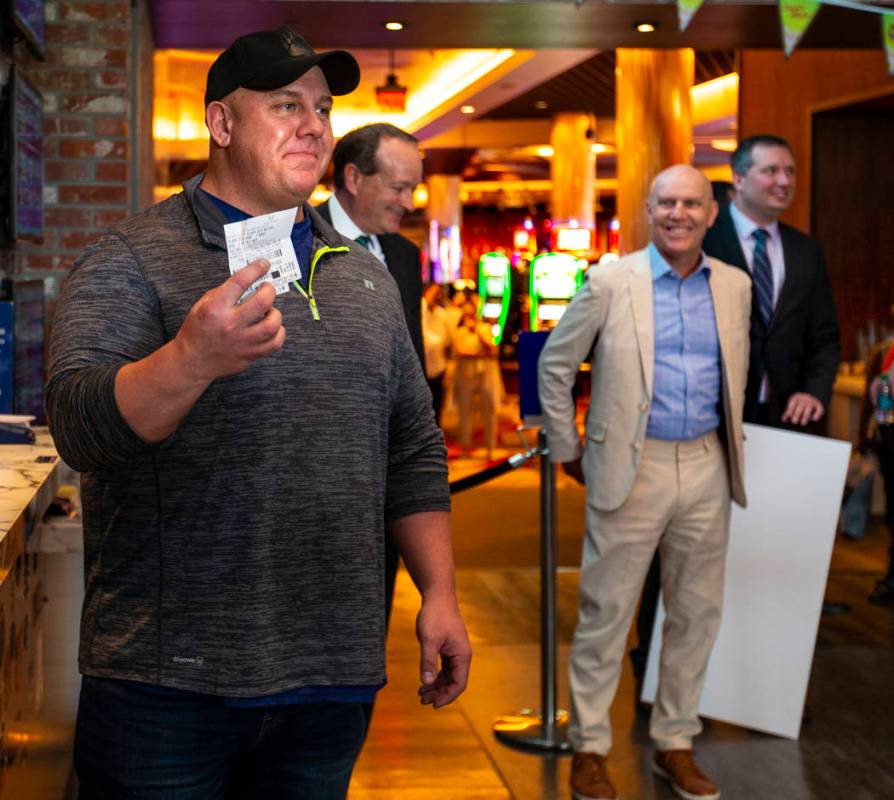 James Adducci of Wisconsin shows off his $1,190,000 winning payout tickets from the William Hil ...