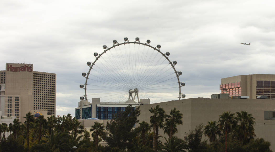 A plane flies with the High Roller nearby departing from McCarran International Airport on Tues ...