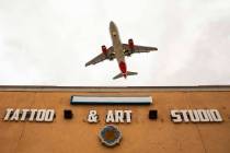 A plane flies low over Lokahi Studios near McCarran International Airport on Tuesday, April 16, ...