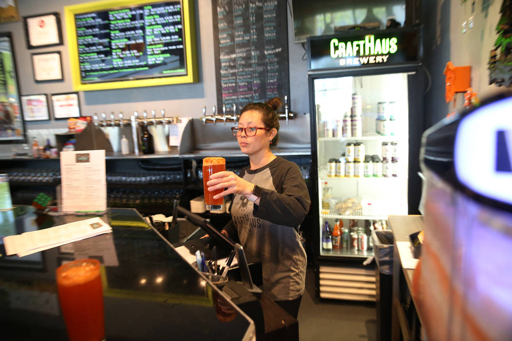 Beertender Chelsie Kesjaral serves a beer at CraftHaus Brewery in Henderson, Saturday, April 13 ...