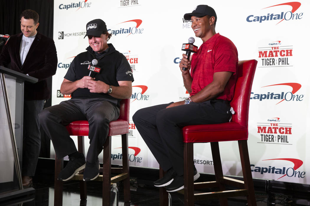 Phil Mickelson, second left, and Tiger Woods take questions during a press conference at Shadow ...