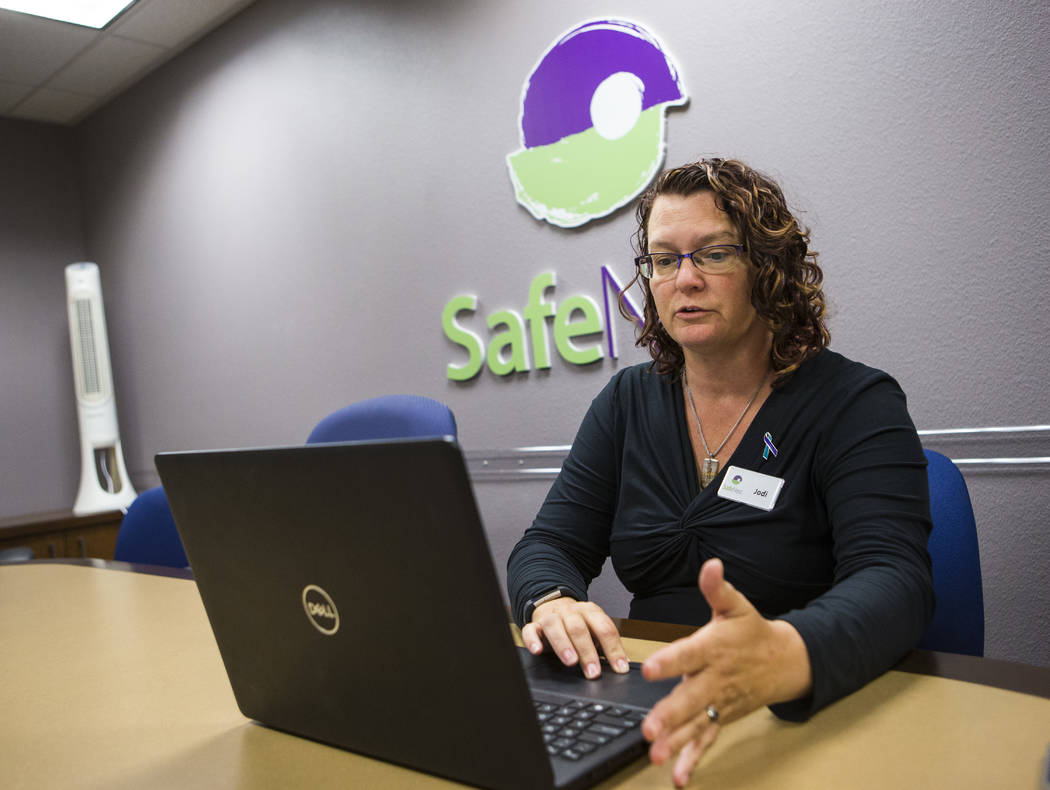 Jodi Pudwill, manager of the SafeNest hotline, demonstrates the online chat features that were ...