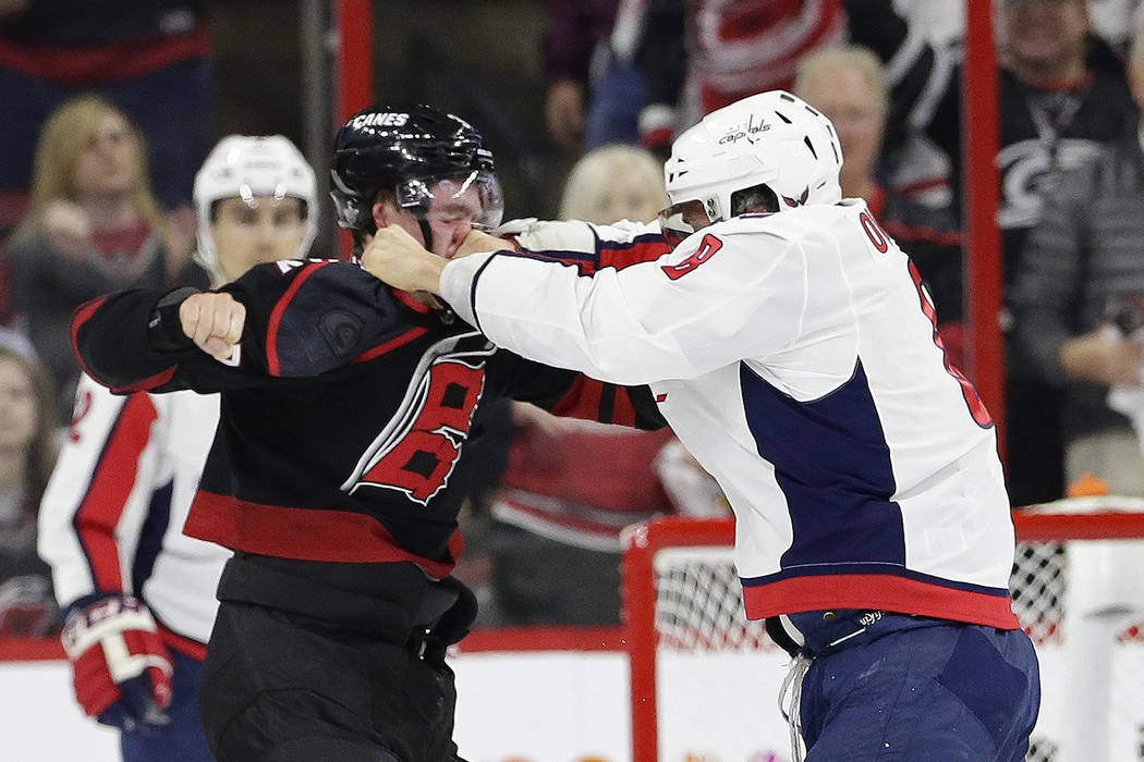 Washington Capitals' Alex Ovechkin, right, of Russia, punches Carolina Hurricanes' Andrei Svech ...